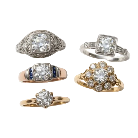Five vintage-style diamond rings displayed on a light gray background, including silver, rose gold, yellow gold, and blue accent designs.